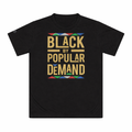 Black t-shirt with 'Black by Popular Demand' text and colorful design on a white background