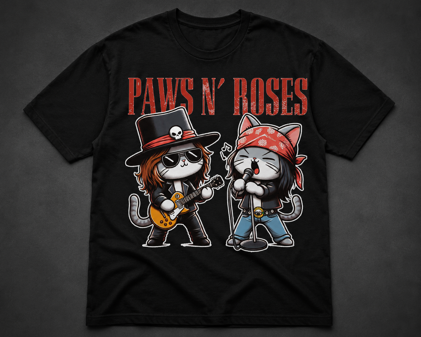 Black t-shirt with 'Paws N' Roses' design featuring cartoon cats playing guitar and drums on a dark background.