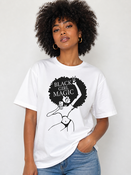 Person wearing a white t-shirt with 'Black Girl Magic' graphic design on a plain background