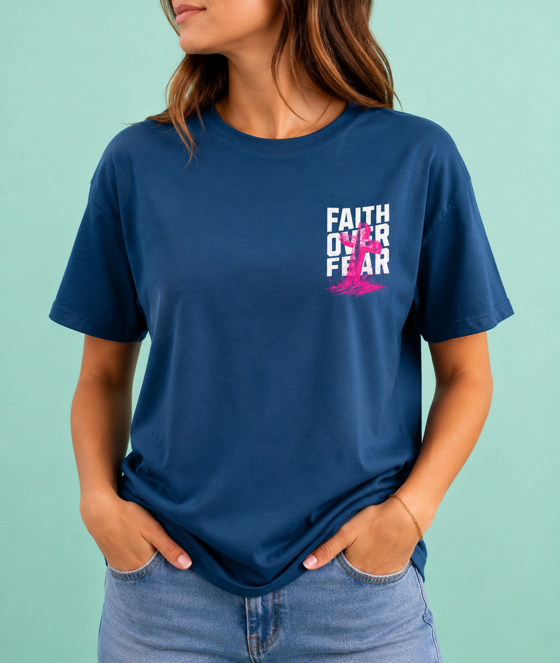 Person wearing a blue t-shirt with 'Faith Over Fear' design on a light green background