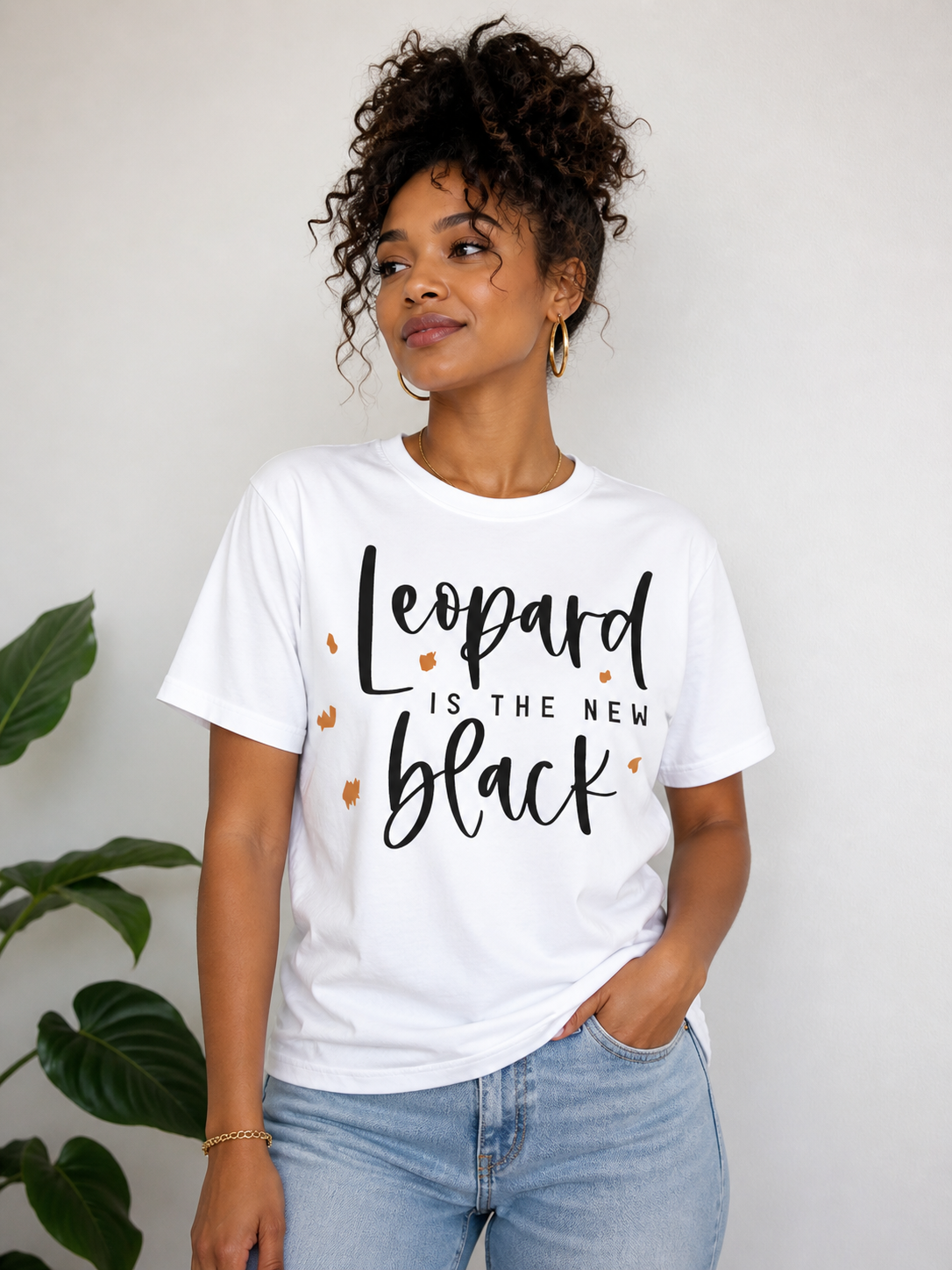 Person wearing a white t-shirt with 'Leopard is the new black' text.