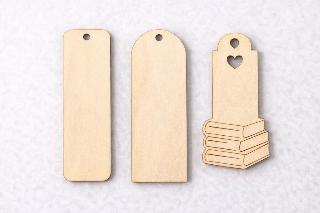 Three wooden bookmarks on a light gray background