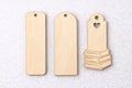 Three wooden bookmarks on a light gray background